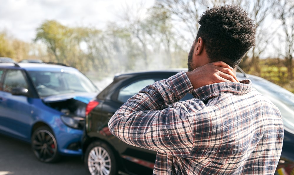 Person With A Strained Looking At A Two Light Vehicle Car Crash