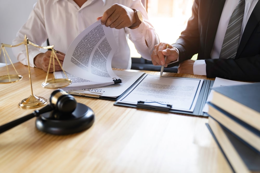 Judges Hammer With Scales next To A Set Of documents