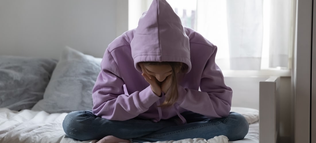 Girl sitting on bed